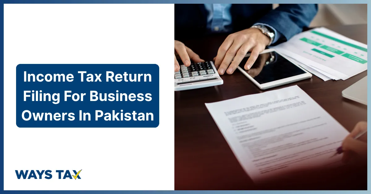 A promotional banner for Income Tax Return Filing for Business Owners in Pakistan by Waystax. The left half features a clean white background displaying the bold text header in a dark blue box above the blue and yellow "WAYS TAX" corporate logo. The right half shows a close-up of a business owner or accountant's hands working at a wooden desk, using an office calculator, interacting with a digital tablet, and preparing financial tax compliance documents.